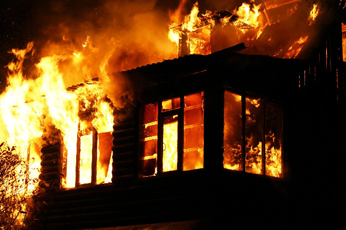 Photo of house engulfed in flames